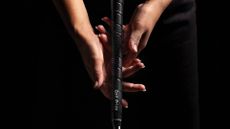 Female golfer gripping club