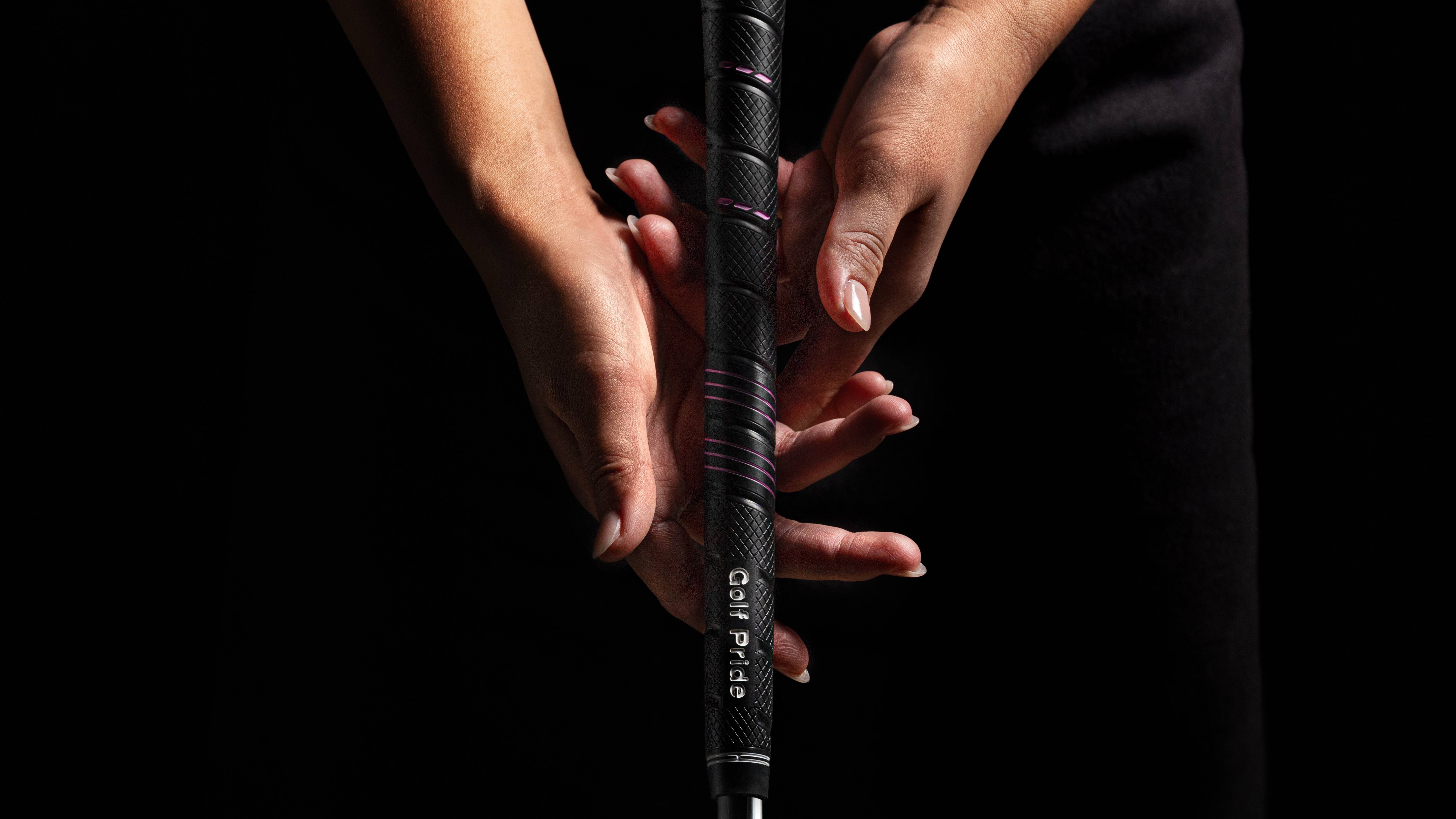 Female golfer gripping club