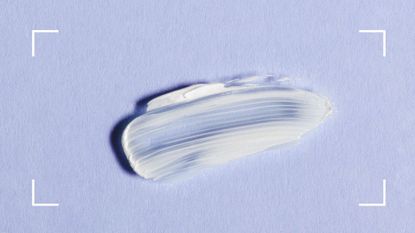 A slick of white cosmetic cream on a lilac background that could either be glycerol vs glycerin