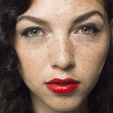 Woman with freckles and red lipstick