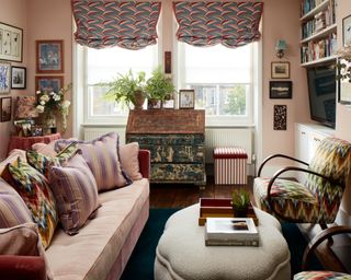 colorful eclectic living room with pink walls and pink sofa, bentwood chair with zig zag pattern and shaped ottoman