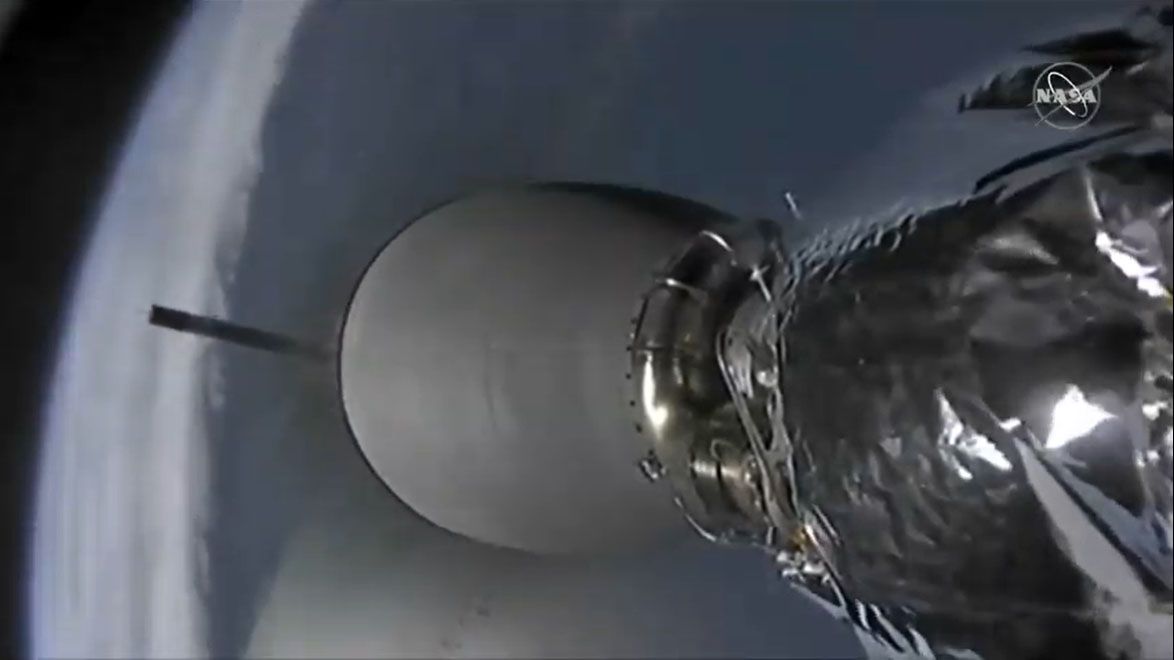 The first stage of a SpaceX Falcon 9 rocket (background left) falls away from its second stage in this view from a camera on the second stage taken on Dec. 5, 2019 during the CRS-19 Dragon cargo launch.