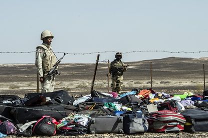 Soldiers stand over luggage from the Metrojet plane that crashed in Egypt's Sinai Peninsula.