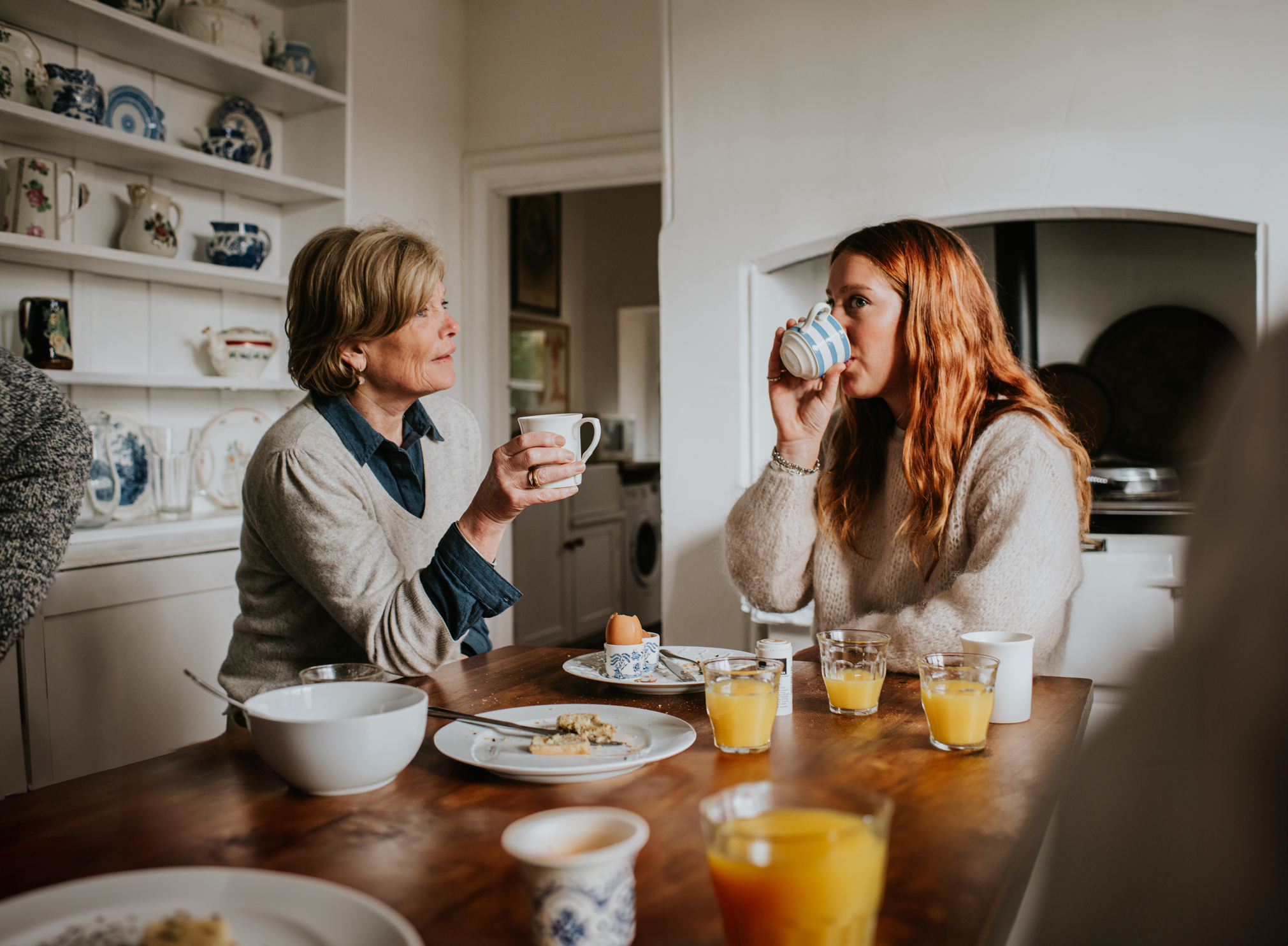A mother and daughter having breakfast at home. Missing National Insurance credits mainly affected mothers who opted out of child benefit to avoid the high income child benefit charge