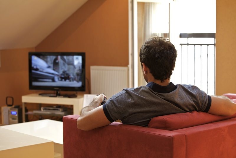 A man watches television.