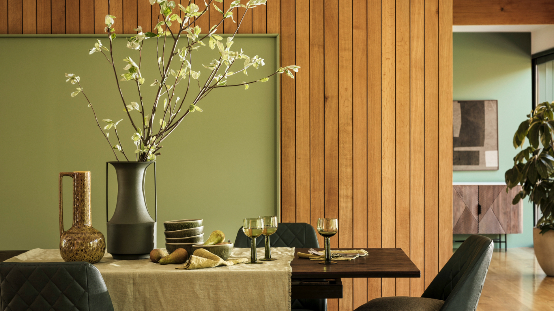 Dining table with foliage in vase