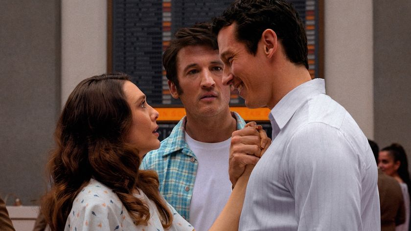 Elizabeth Olsen staring up at Callum Turner while Miles Teller watches in Eternity