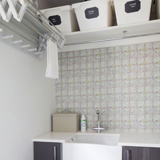 room with sink and clothes rail
