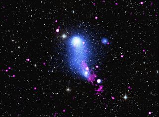 A few hundred millions years ago, two galaxy clusters collectively known as Abell 2384 collided, passing through each other and creating a "bridge" of hot gas between the clusters that spans more than 3 million light-years. A new composite image of Abell 2384 has revealed that a supermassive black hole lurking at the center of one of these galaxy clusters is shaping this galactic bridge by blasting it with a powerful jet of energetic particles. The new image combines X-ray data from Europe's XMM-Newton telescope and NASA's Chandra X-ray Observatory (shown in blue), along with radio observations from the Giant Metrewave Radio Telescope in India (shown in red) and optical data from the Digitized Sky Survey (shown in yellow).