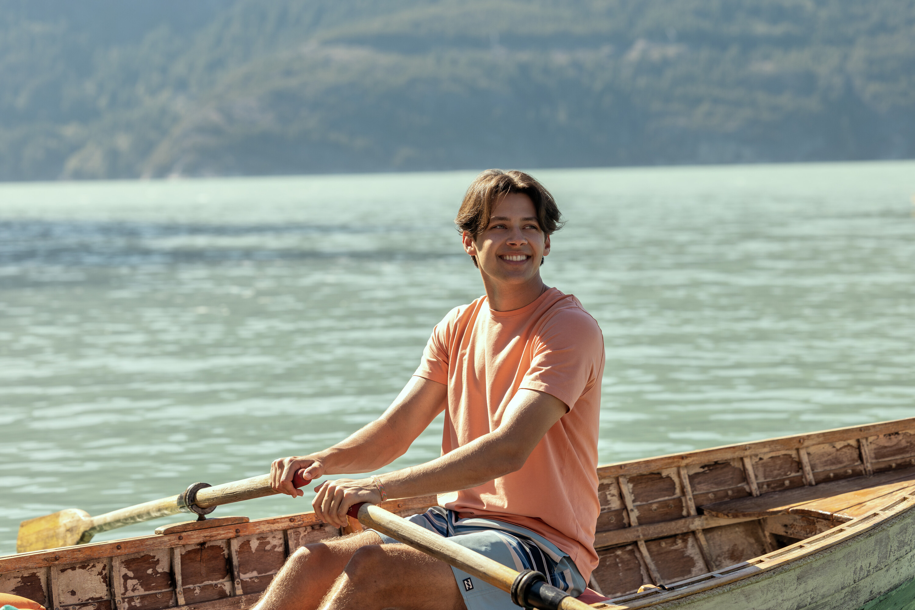 Matt Cornett's character Sam rowing a boat on a lake in a scene from 'Every Year After.'