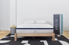 A Helix midnight mattress in a bedroom next to a box
