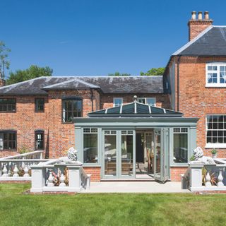 Conservatory exterior with roof lantern and bifold doors to the garden