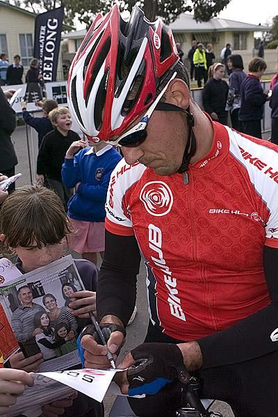 Sign here please: A Berettas Bike Hub rider signs autographs for a young fan in Geelong.