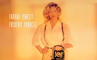 Farrah Fawcett standing with camera