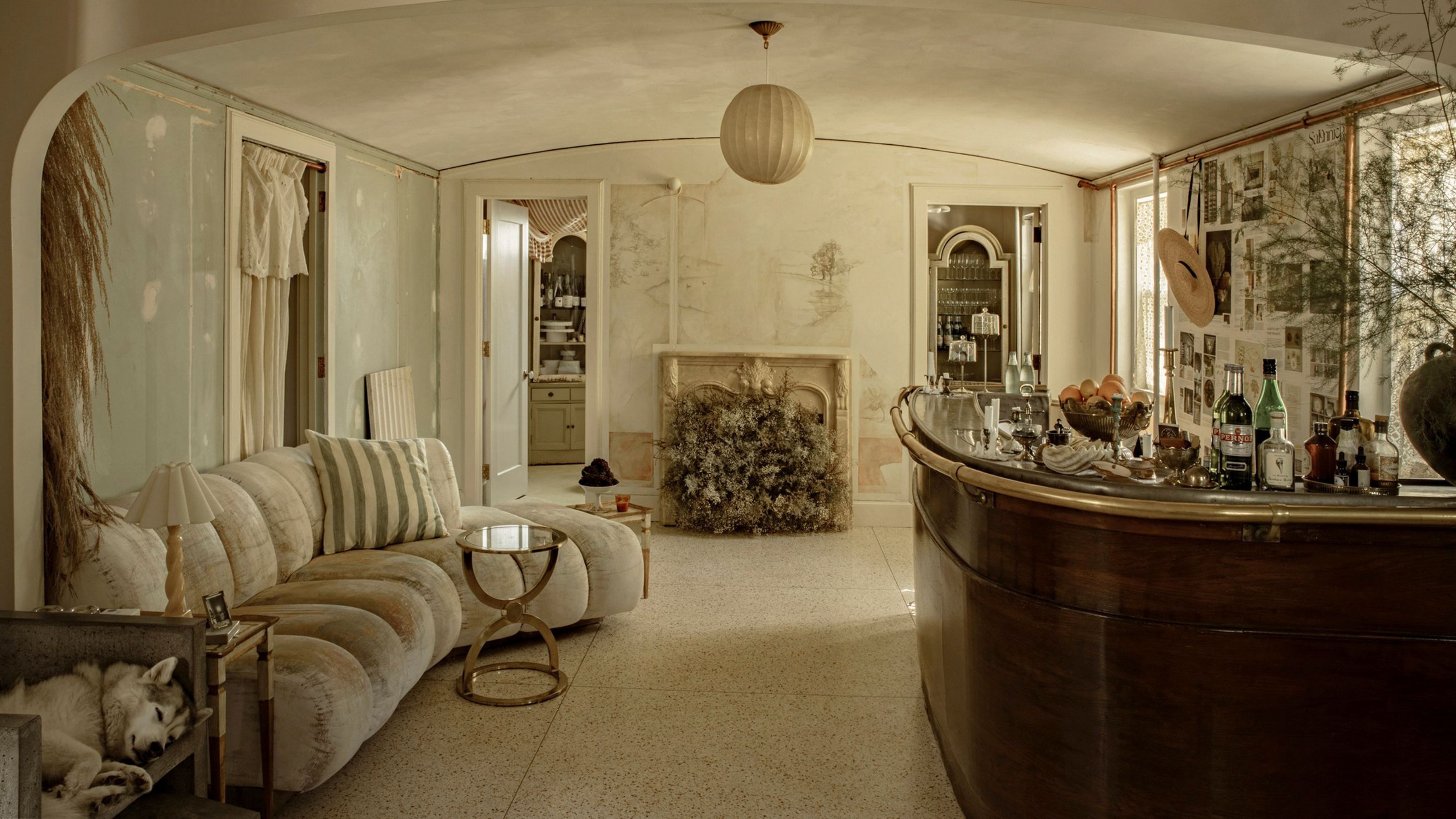 a large vintage style bar and entertaining space with antique fireplace, decor and space for dancing