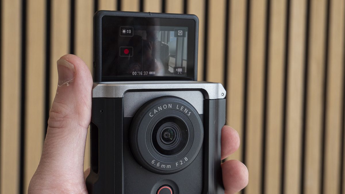 Canon Powershot V10 in the hand with screen flipped up