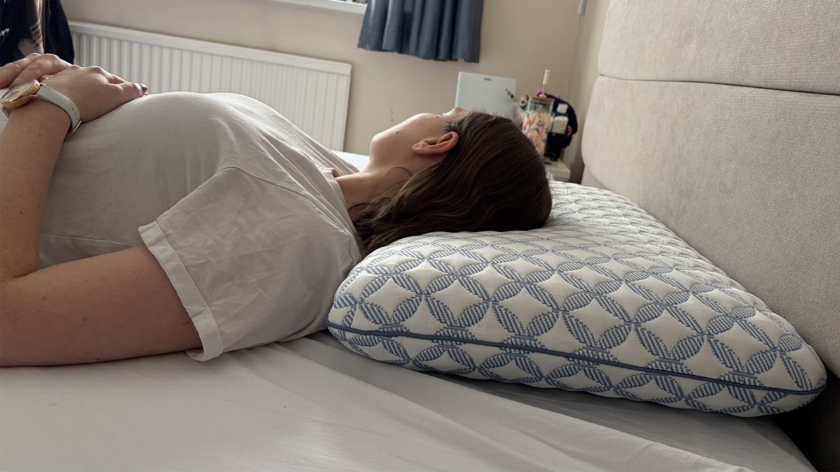 Tester Ruth Jones lies on the Helix Cooling Memory Foam Pillow in her bedroom, in a back sleeping position