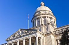 Kentucky state capitol building against bright blue sky