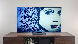 Sansui 55-inch OLED TV on stand in living room