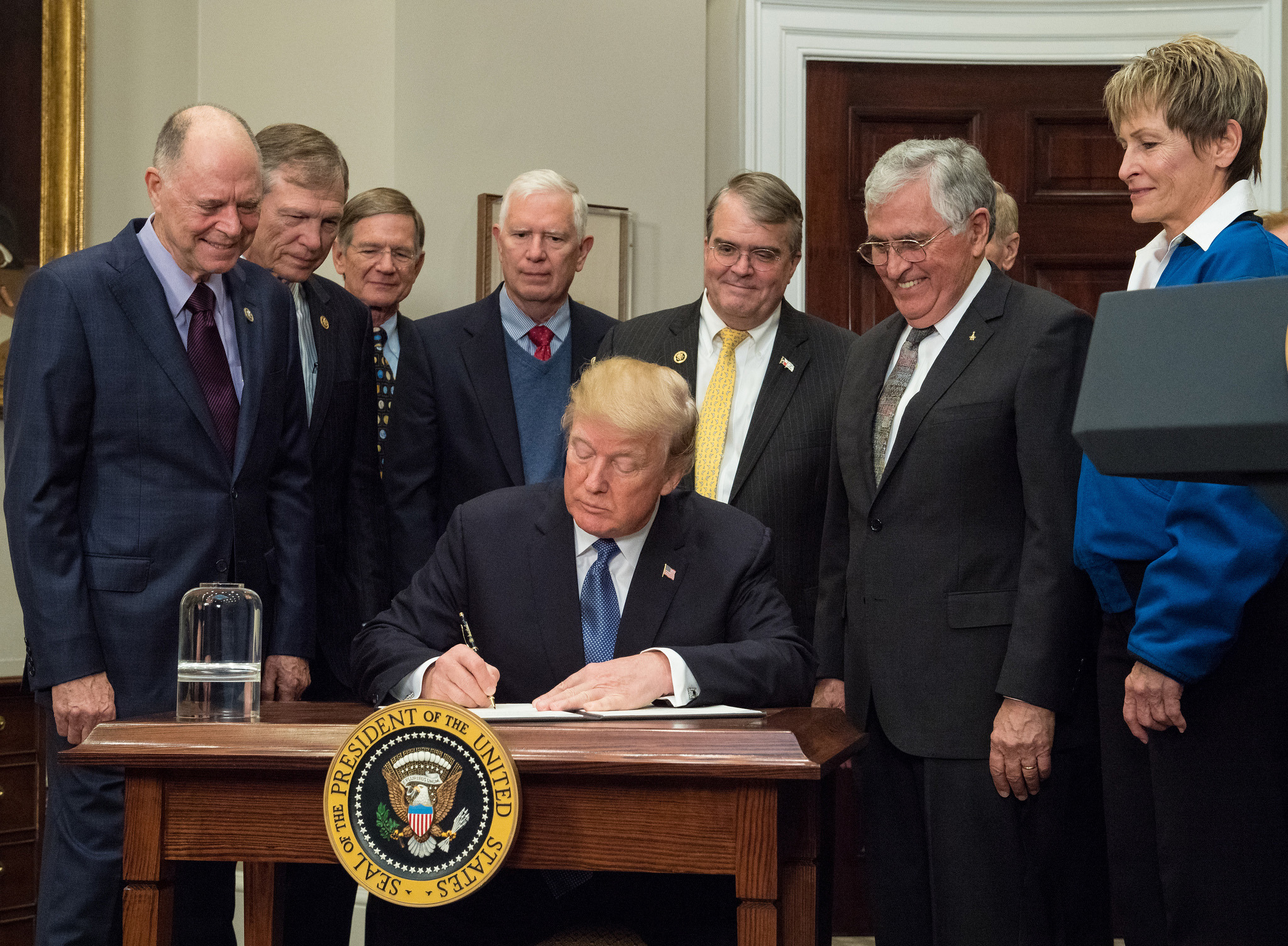 President Donald Trump signs the Space Policy Directive 1 directing NASA to return astronauts to the moon on December 11, 2017.