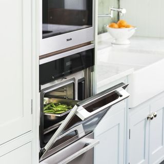 kitchen with fruit bowl white cabinet and oven
