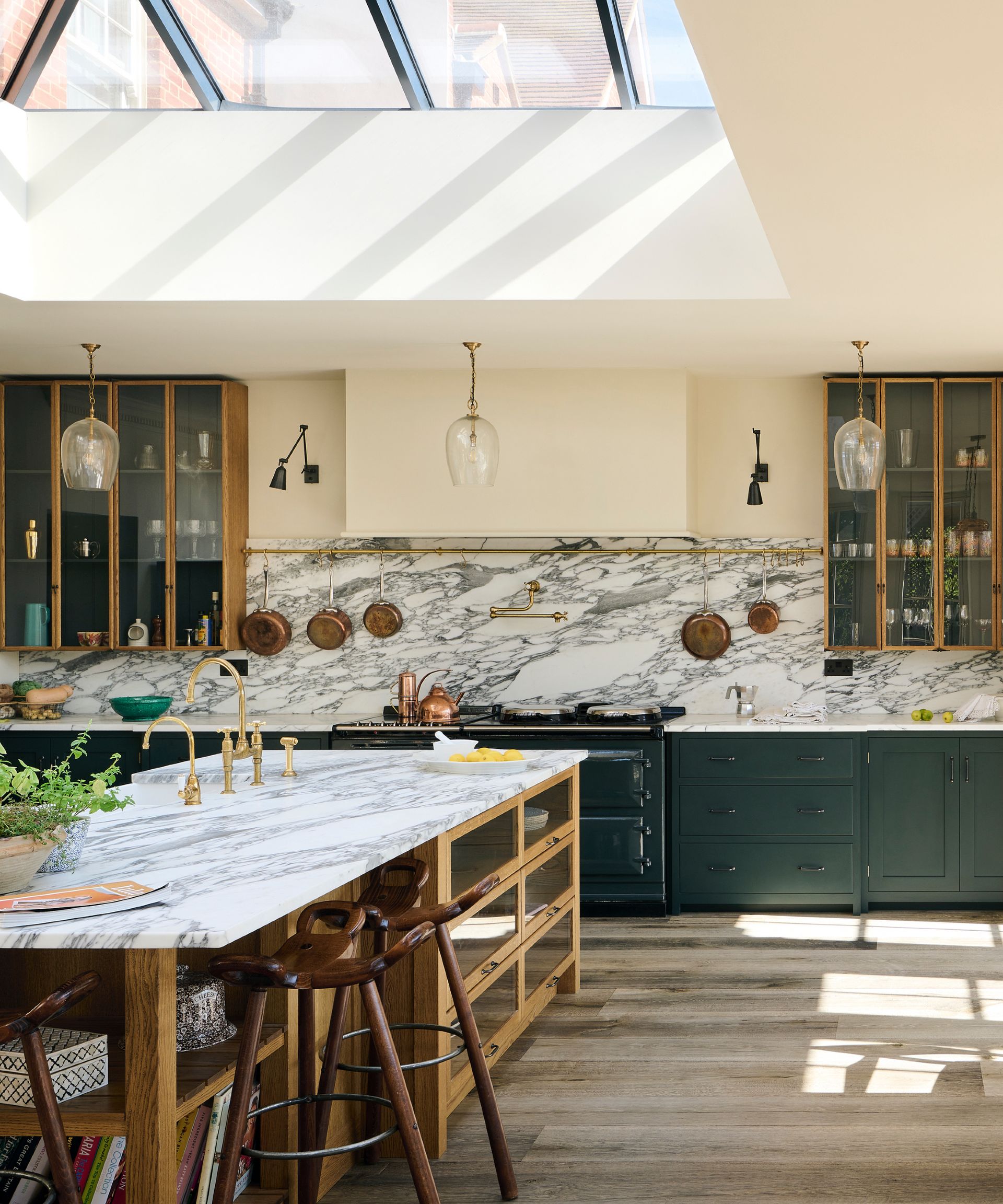 best green paints, green cabinets with marble countertops on cabinetry and island, backsplash, glazed wall units, copper pans hanging