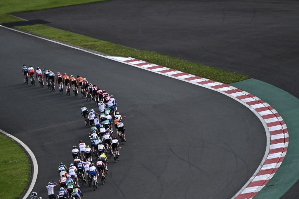 The peloton rides in the Fuji International Speedway during the mens cycling road race of the Tokyo 2020 Olympic Games in Oyama Japan on July 24 2021 Photo by Jeff PACHOUD AFP Photo by JEFF PACHOUDAFP via Getty Images