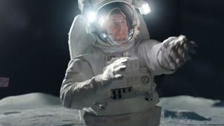 NFL star Tim Tebow wears a spacesuit on the moon in this still from T-mobile's Super Bowl XLVIII ad.
