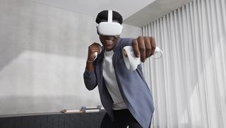An Oculus Quest headset wearer punching forwards with their controllers
