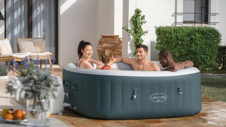 hot tub vs Jacuzzi - people sitting in an inflatable hot tub on a patio