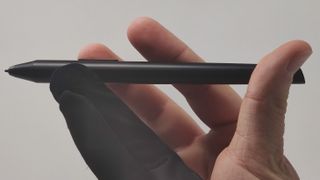 XP-Pen Artist 10 stylus being held in a right hand