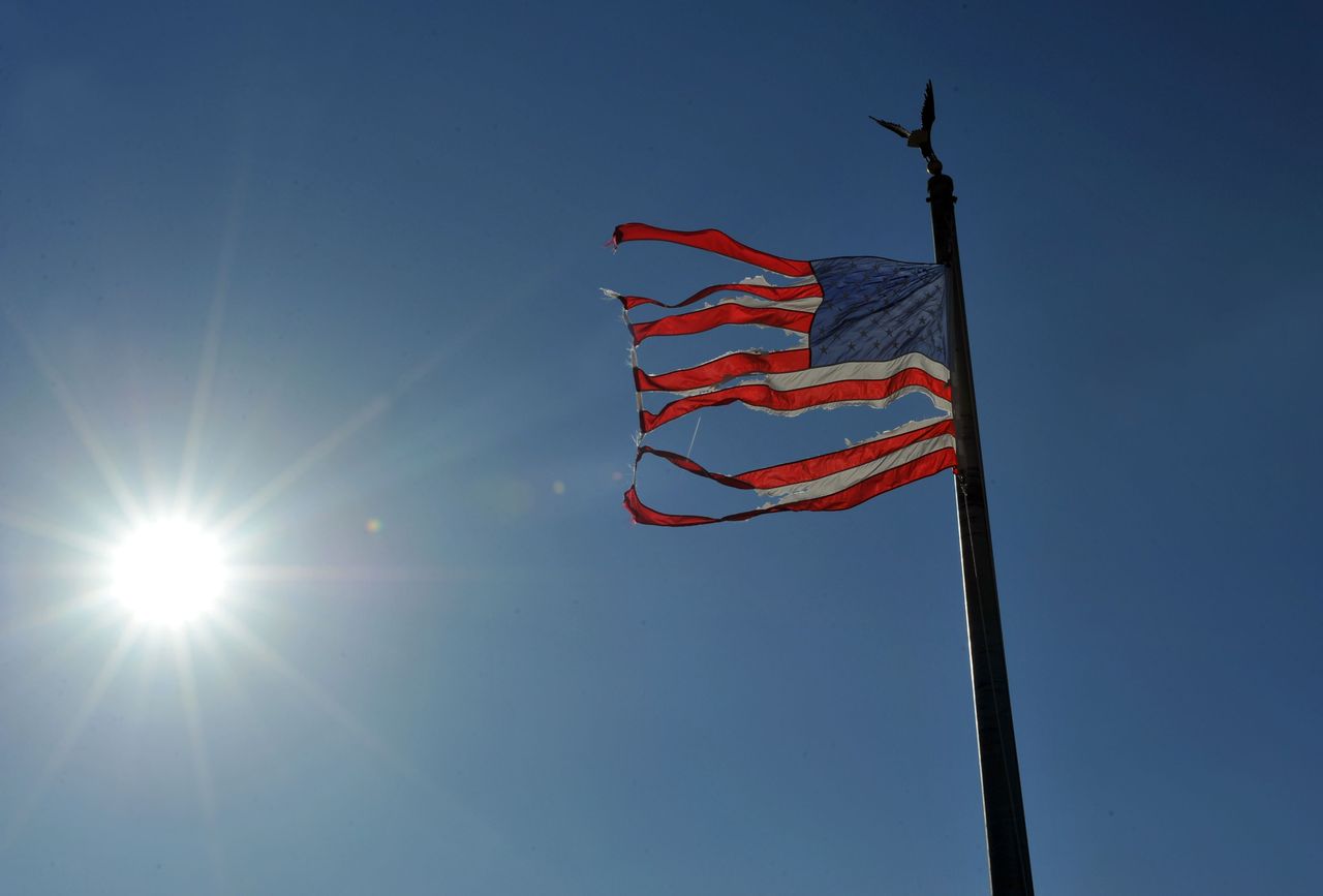 An American flag coming apart at the seams. 