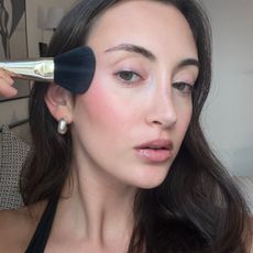 Alyssa Brascia wearing and applying blush.