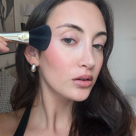 Alyssa Brascia wearing and applying blush.