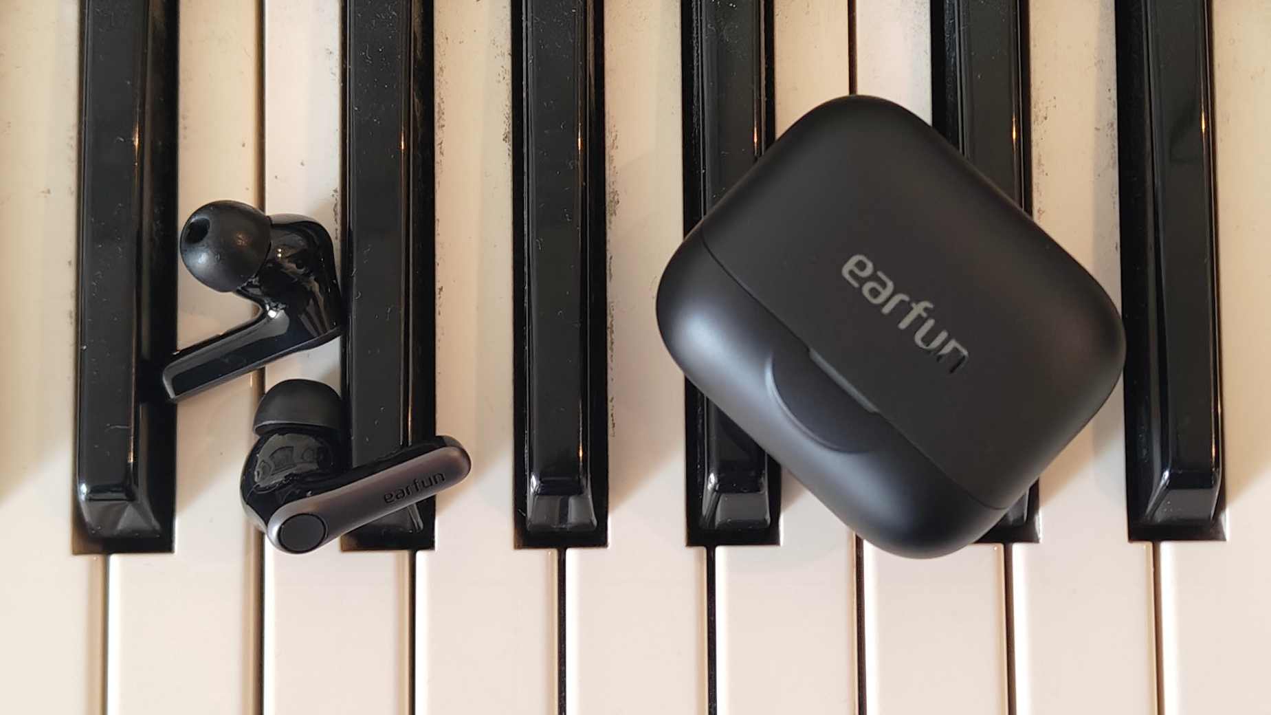 The Earfun Air Pro 4 Plus on top of a keyboard.