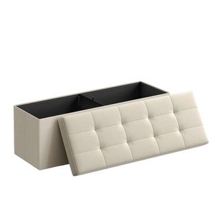 A beige storage ottoman with a tufted button lid