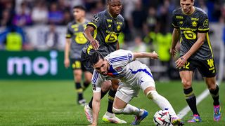 Rayan Cherki of Lyon (R) is challenged by Bafode Diakite of Lille during the Ligue 1 McDonald's match in April 2025