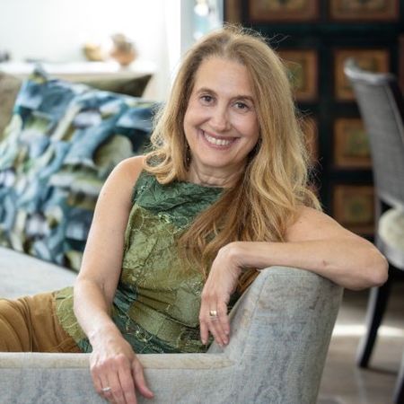 Image of Lori Weitzner sat on a gray chair