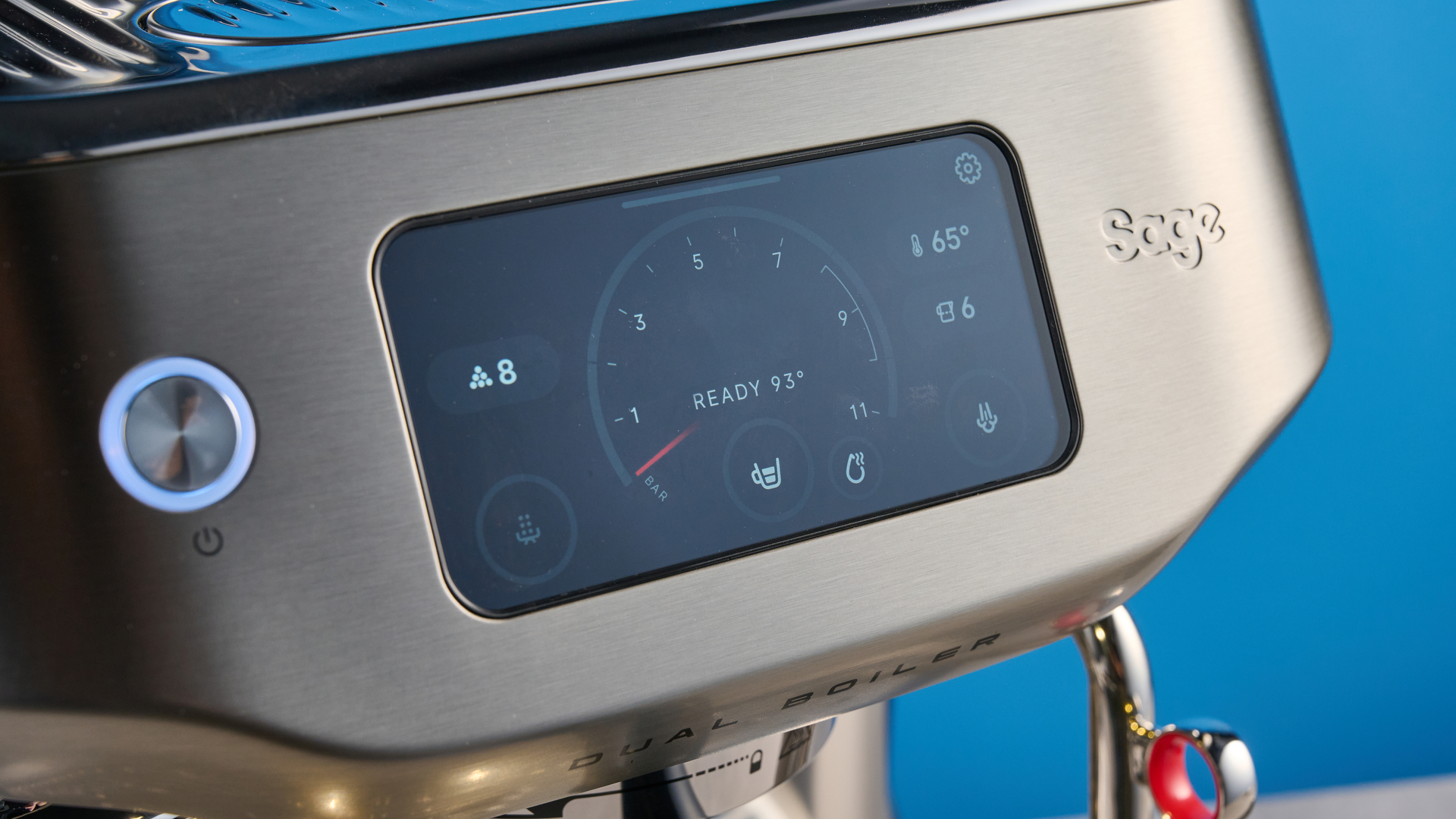 the breville oracle dual boiler / sage oracle dual boiler in stainless steel, showing its touchscreen, steam wand, built in grinder, and espresso shots