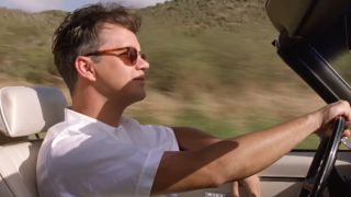 Tim Robbins driving a convertable while wearing sunglasses in The Shawshank Redemption.