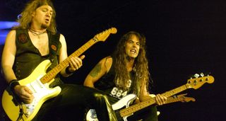 Adrian Smith and Steve Harris of Iron Maiden lock in onstage as they perform Long Beach in 2003. Smith plays his Olympic White Fender Strat. Harris is on his trusty Precision Bass.