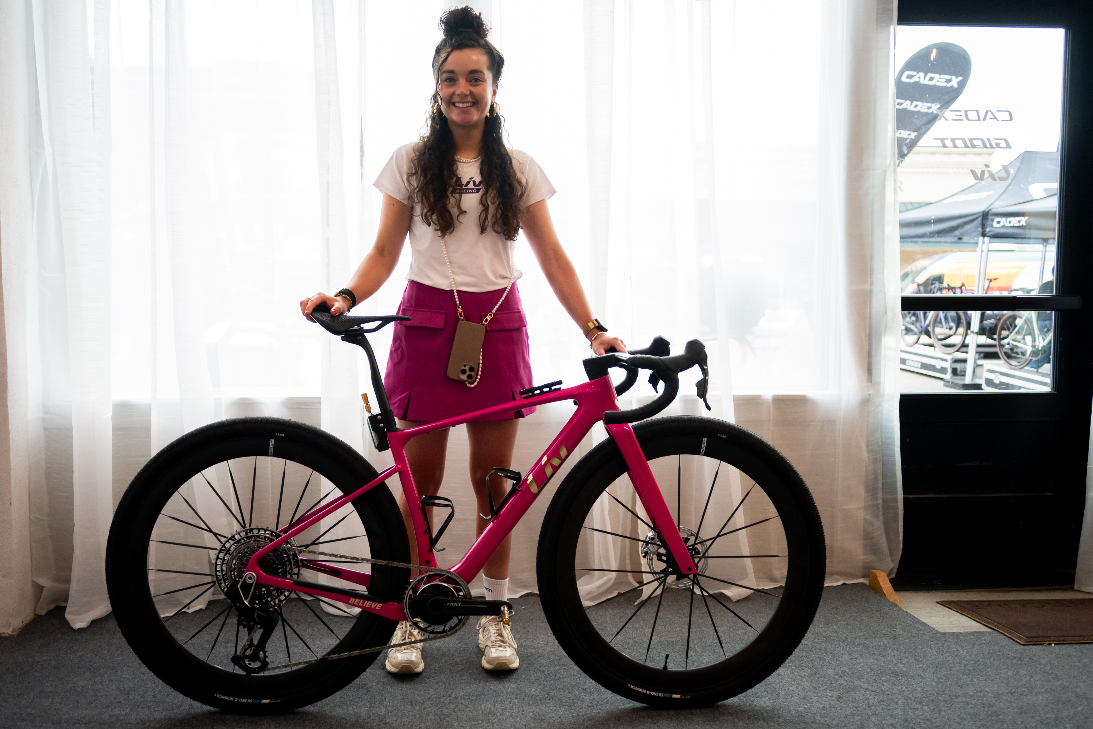 Neefjes standing behind her bike in a hotel room