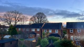 a suburban street under a blue and pink sunrise