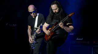 Joe Satriani (left) and John Petrucci perform onstage on April 2, 2018 in Rome, Italy