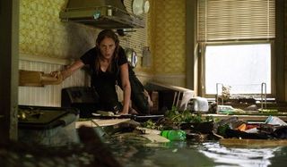 Crawl Kaya Scodelario perched on top of the stove, waiting for a gator