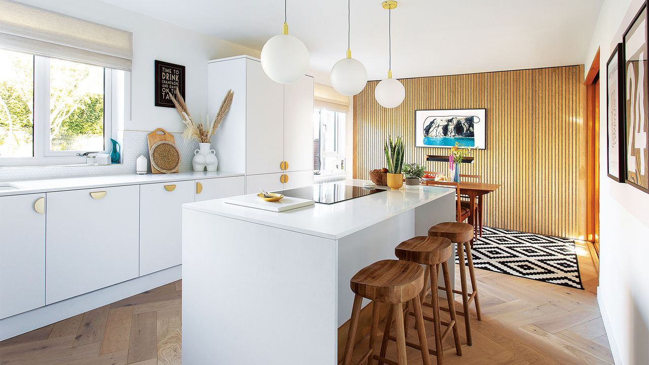 white kitchen with island and wood veneer feature wall