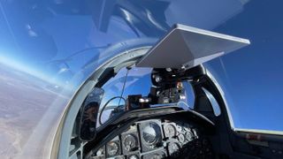 a white square mounted to the top of an aircraft canopy