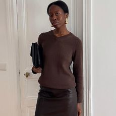 Woman in brown sweater and skirt