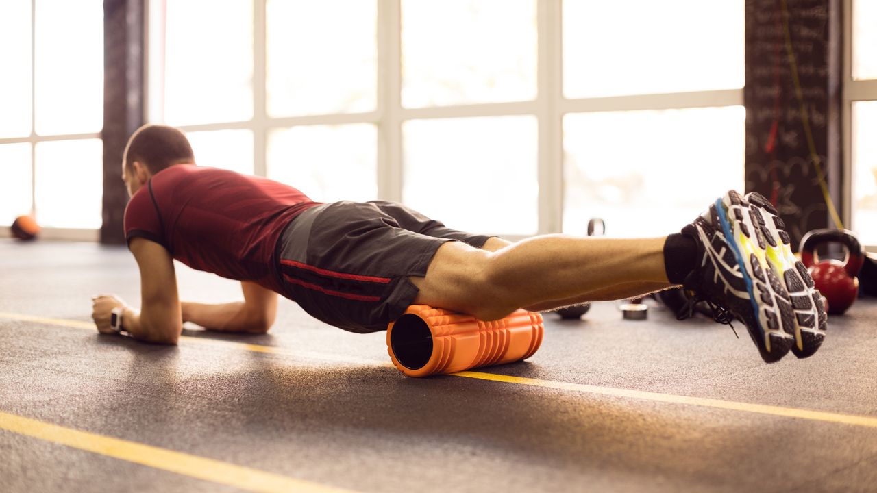 Man using a foam roller to undo the damage of sitting