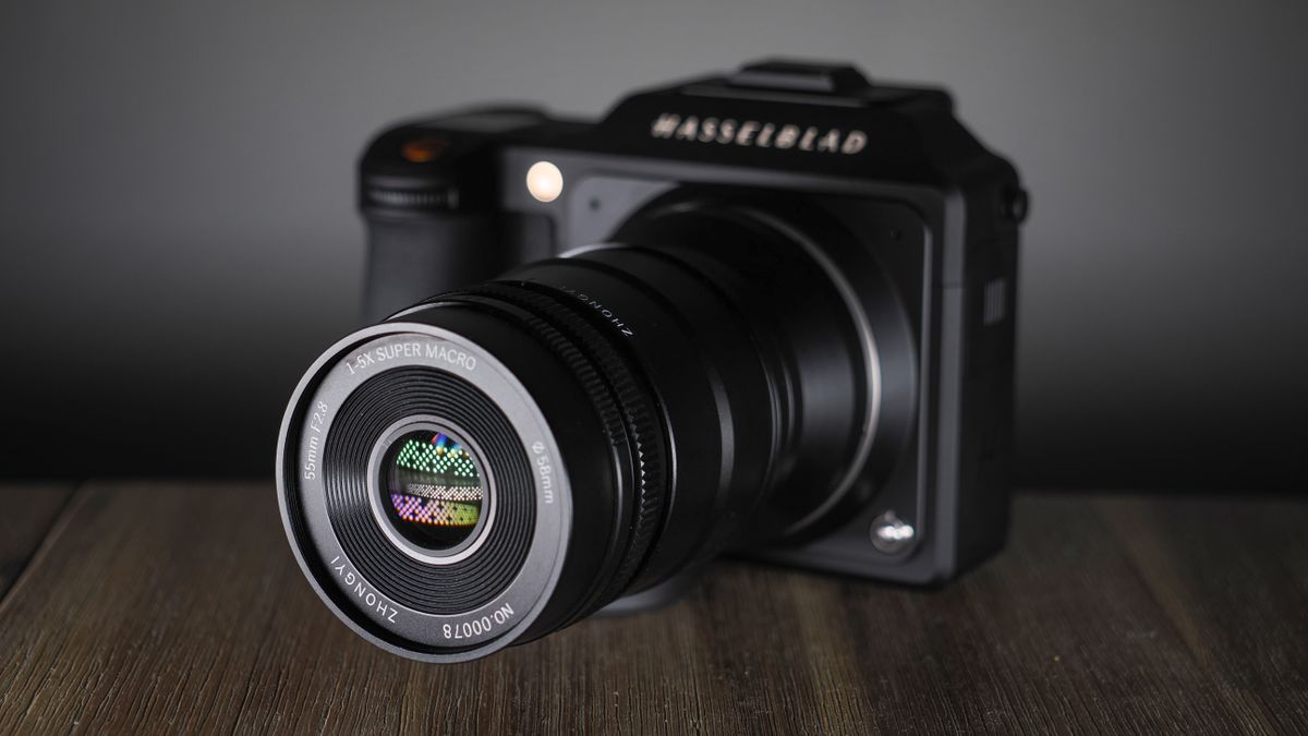 Mitakon 55mm f/2.8 1-5x Macro mounted to. a Hasselblad X2D, on a wooden surface